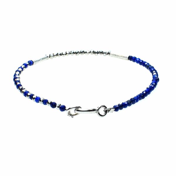 Handmade bracelet with natural, faceted lapis lazuli and pyrite gemstones in a spherical shape and decorative elements made of sterling silver.