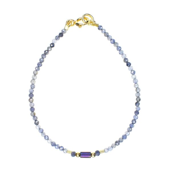 Handmade bracelet with natural, faceted, spherical shaped iolite gemstones and one cylindrical oxidized agate element in the center. The bracelet has decorative elements and clasp made from gold plated sterling silver.