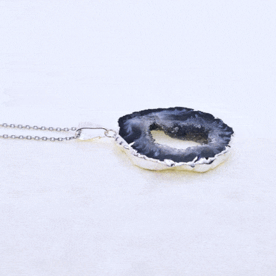 Pendant made of natural agate gemstone with crystal quartz and hypoallergenic silver plated metal. The agate is polished on both sides and the pendant is threaded on a sterling silver chain with adjustable length. Buy online shop.
