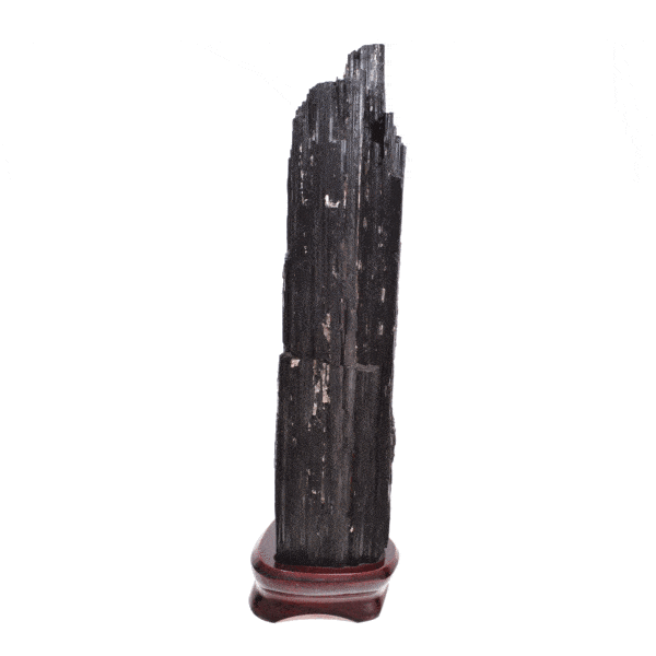 Raw piece of natural black tourmaline gemstone, with a size of 32cm. The tourmaline is placed on a wooden base. Buy online shop.