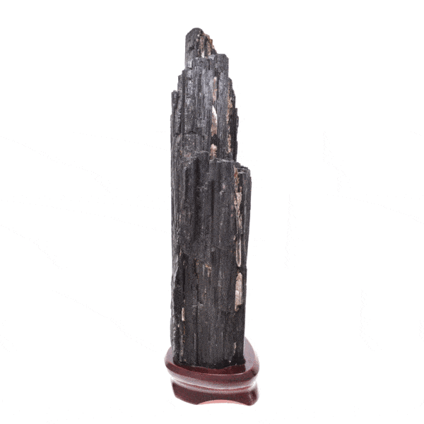 Raw piece of natural black tourmaline gemstone, with a size of 32cm. The tourmaline is placed on a wooden base. Buy online shop.