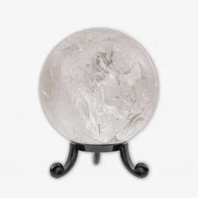 Polished 6.5cm diameter sphere made from natural  crystal quartz. The sphere comes with a black plexiglass base. Buy online shop.