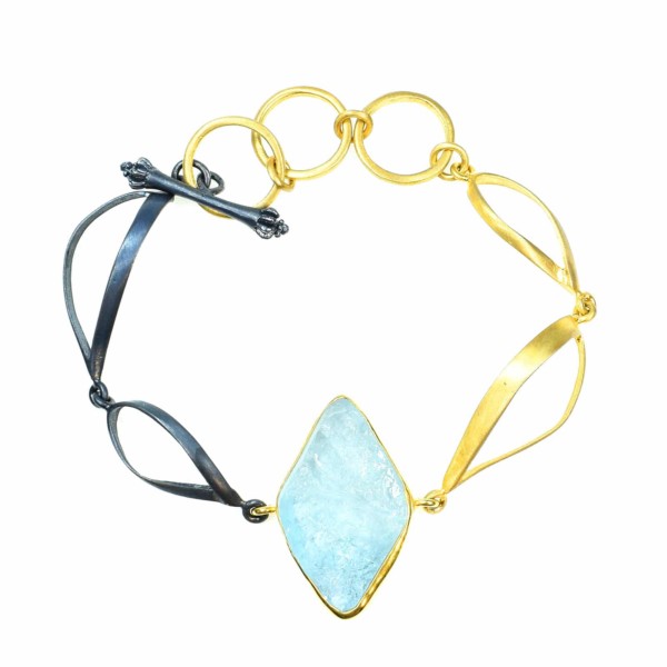 Handmade bracelet made of gold plated sterling silver and oxidized sterling silver, with a raw piece of Aquamarine as a central element. Buy online shop.