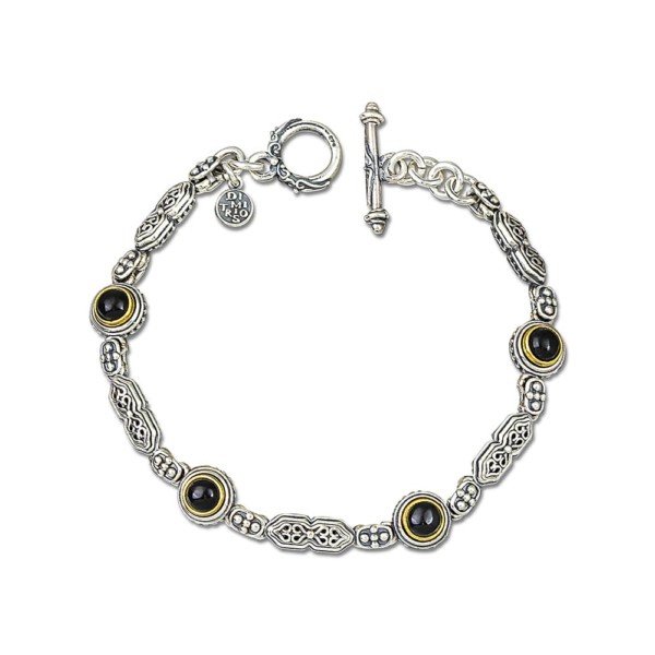 Handmade bracelet made of sterling silver with gold plated details and black onyx stones, in round shape. Buy online shop.
