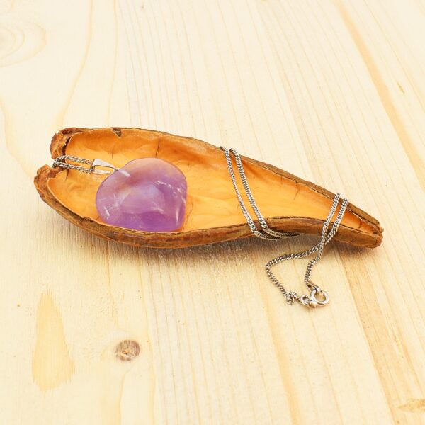 Pendant made of Amethyst, in the shape of heart, threaded on a thin chain made of sterling silver. Buy online shop.