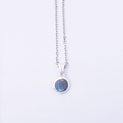 Handmade pendant made of sterling silver and natural, faceted labradorite gemstone in a round shape. The pendant is threaded on a sterling silver chain. Buy online shop.