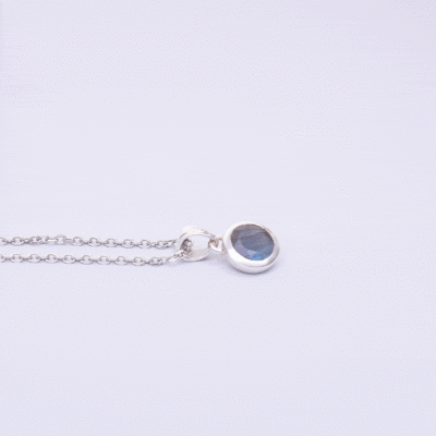 Handmade pendant made of sterling silver and natural, faceted labradorite gemstone in a round shape. The pendant is threaded on a sterling silver chain. Buy online shop.