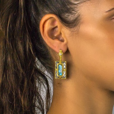 Handmade earrings made of sterling silver with gold plated details and Turquoise gemstones in parallelogram shape. Buy online shop.
