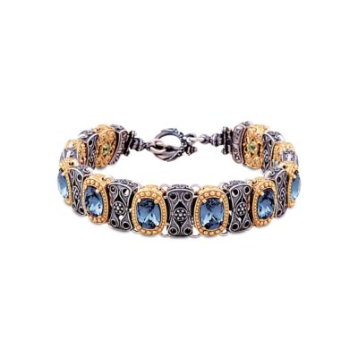 Handmade reversible bracelet made of sterling silver with gold plated details, blue crystals and semi-precious stones. Buy online shop.