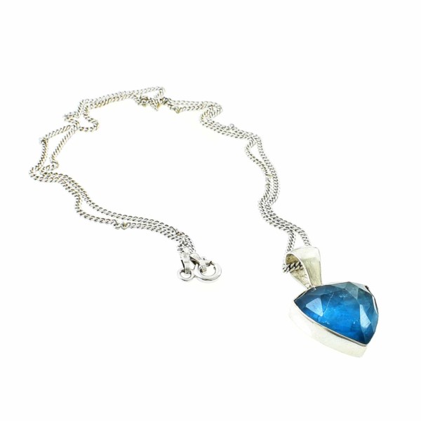 Pendant made of sterling silver and doublet made of crystal quartz and apatite. The doublet consists of two layers of stones. The upper stone is crystal quartz faceted cut and the stone at the bottom is apatite. The pendant is threaded on a sterling silver chain.