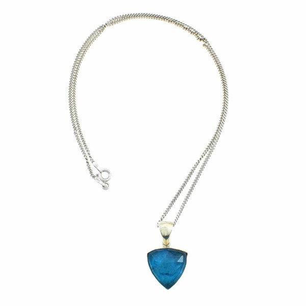 Pendant made of sterling silver and doublet made of crystal quartz and apatite. The doublet consists of two layers of stones. The upper stone is crystal quartz faceted cut and the stone at the bottom is apatite. The pendant is threaded on a sterling silver chain.