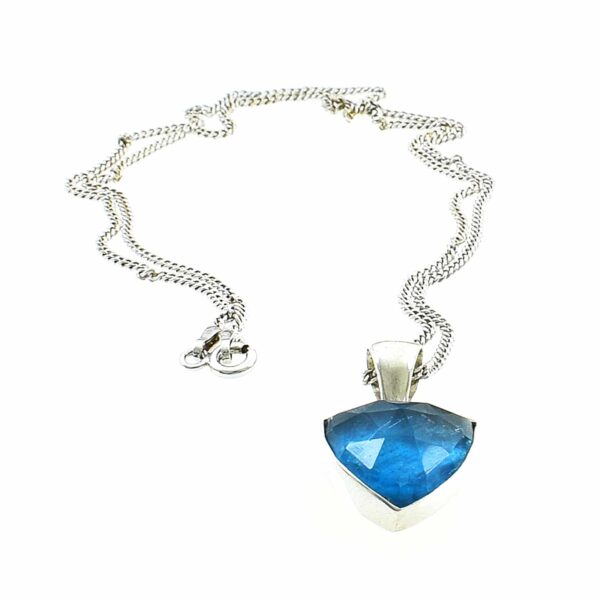 Pendant made of sterling silver and doublet made of crystal quartz and apatite. The doublet consists of two layers of stones. The upper stone is crystal quartz faceted cut and the stone at the bottom is apatite. The pendant is threaded on a sterling silver chain.