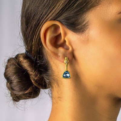 Handmade long earrings made of gold plated sterling silver and blue crystals. Buy online shop.