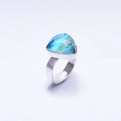 Handmade sterling silver ring with doublet made of chrysocolla and crystal quartz gemstones, in a triangular shape. The doublet consists  of two layers of stones.The upper stone is faceted crystal quartz and the stone at the bottom is chrysocolla. Buy online shop.