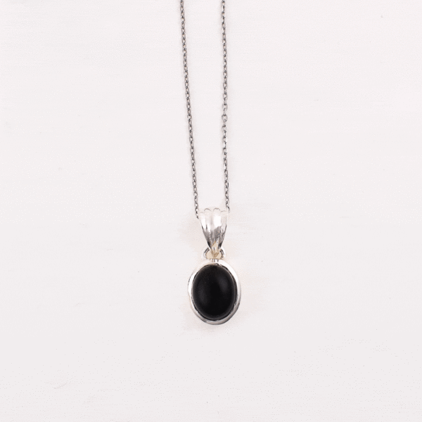 Handmade pendant made of sterling silver and natural onyx gemstone in an oval shape. The pendant is threaded on a sterling silver chain with adjustable length. Buy online shop.