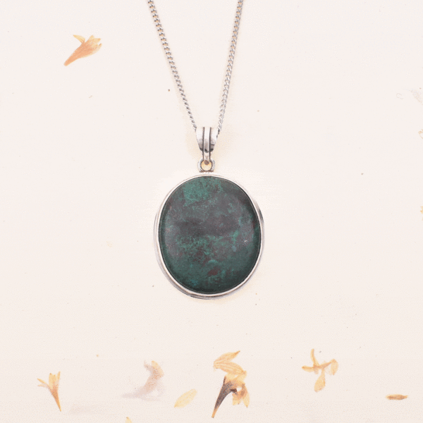 Handmade pendant made of sterling silver and natural chrysocolla gemstone, in an oval shape. The pendant is threaded on a sterling silver chain.