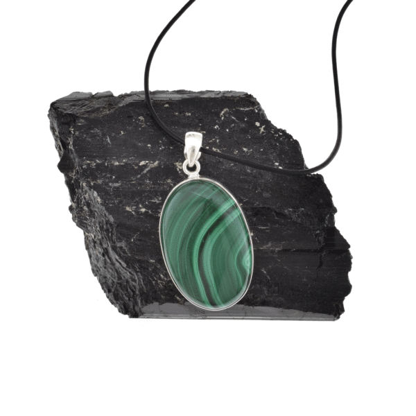 Handmade pendant made of sterling silver and natural malachite gemstone, in an oval shape. The pendant is threaded on a black leather with sterling silver clasp. Buy online shop.