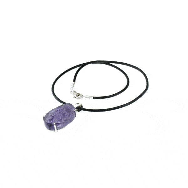 Handmade pendant made of sterling silver and raw Amethyst gemstone, in an oval shape. The pendant is threaded on a black leather, which has sterling silver clasp. Buy online shop.