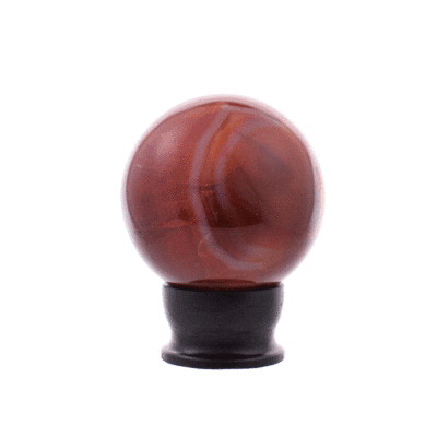 Polished sphere made of natural Carnelian stone, with a diameter of 8cm. The sphere comes with an elegant black wooden stand.