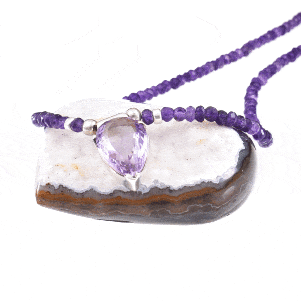 Handmade necklace with natural Amethyst gemstones in a rondel shape and one central Amethyst piece in the shape of tear-drop. The necklace has decorative elements and clasp made of sterling silver. Buy online shop.