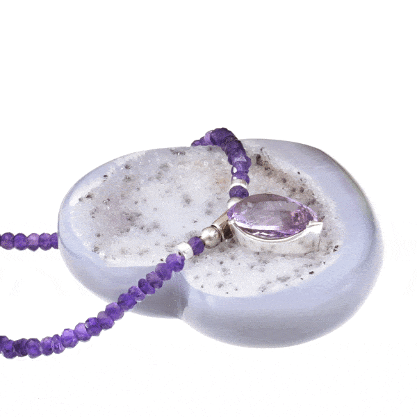 Handmade necklace with natural Amethyst gemstones in a rondel shape and one central Amethyst piece in the shape of tear-drop. The necklace has decorative elements and clasp made of sterling silver. Buy online shop.