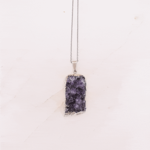 Pendant made of hypoallergenic silver plated metal and natural amethyst gemstone in a raw form. The pendant is threaded on a sterling silver chain with adjustable length. Buy online shop.