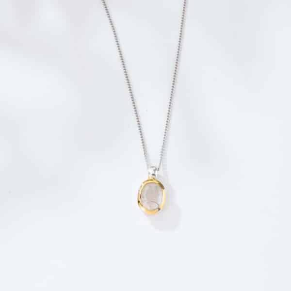 Handmade pendant made of sterling silver with gold plated outline and natural white labradorite gemstone, in an oval shape. The pendant is threaded on a sterling silver chain. Buy online shop.