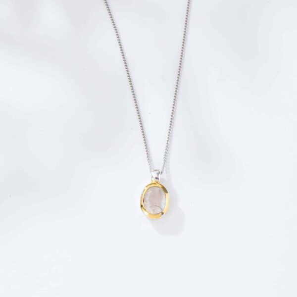 Handmade pendant made of sterling silver with gold plated outline and natural white labradorite gemstone, in an oval shape. The pendant is threaded on a sterling silver chain. Buy online shop.