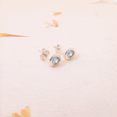 Handmade studded earrings made of sterling silver and natural blue topaz gemstone in a rteardrop shape. Buy online shop.