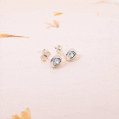 Handmade studded earrings made of sterling silver and natural blue topaz gemstone in a rteardrop shape. Buy online shop.