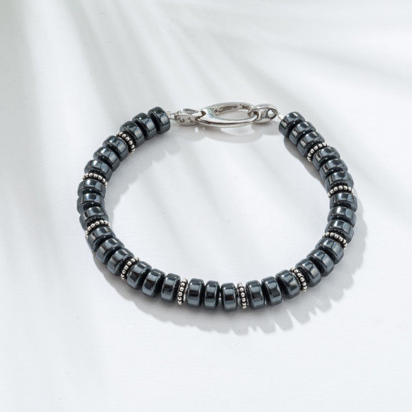 Handmade bracelet with natural hematite gemstones and both decorative elements and clasp made of sterling silver. Buy online shop.
