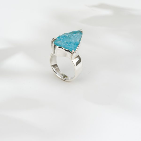 Handmade ring made of sterling silver and natural blue topaz gemstone in a rough form. Buy online shop.