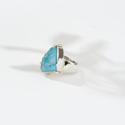 Handmade ring made of sterling silver and natural blue topaz gemstone in a rough form. Buy online shop.