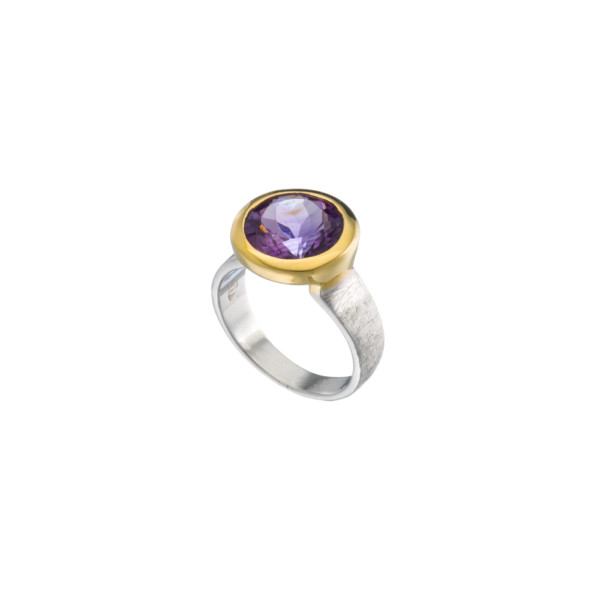 Handmade ring made of sterling silver and natural amethyst gemstone in a round shape. The ring has textured band and gold plated bezel. Buy online shop.