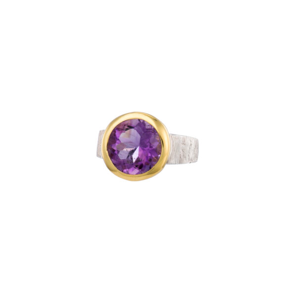 Handmade ring made of sterling silver and natural amethyst gemstone in a round shape. The ring has textured band and gold plated bezel. Buy online shop.