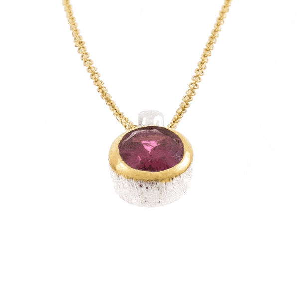 Handmade pendant made of sterling silver with gold plated bezel and natural pink tourmaline gemstone, in an oval shape. The pendant is threaded on a gold plated sterling silver chain with adjustable length. Buy online shop.