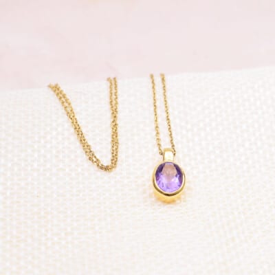Handmade pendant made of gold plated sterling silver and natural, faceted amethyst gemstone, in an oval shape. The pendant is threaded on a gold plated sterling silver chain with adjustable length. Buy online shop.