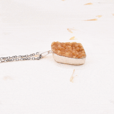 Pendant made of hypoallergenic silver plated metal and citrine quartz gemstone in a natural form. The pendant is threaded on a sterling silver chain. Buy online shop.
