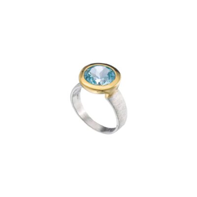 Handmade ring made of sterling silver and natural blue topaz gemstone in a round shape. The ring has textured band and gold plated bezel. Buy online shop.