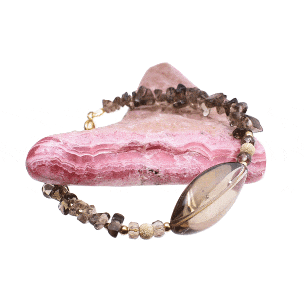 Handmade bracelet with natural smoky quartz and pyrite gemstones in an irregular, oval and spherical shape. The bracelet has a clasp and decorative elements made from gold plated sterling silver. Buy online shop.