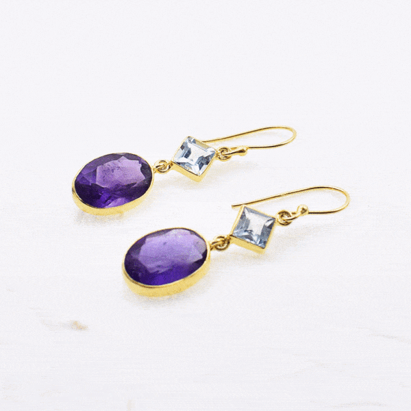 Handmade gold plated sterling silver long earrings with natural Amethyst gemstone in oval shape and Blue Topaz gemstone in rhombus shape. Buy online shop.