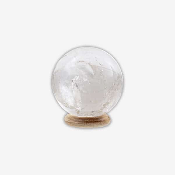 Polished 5cm diameter sphere made from natural  crystal quartz. The sphere comes with a wooden base. Buy online shop.