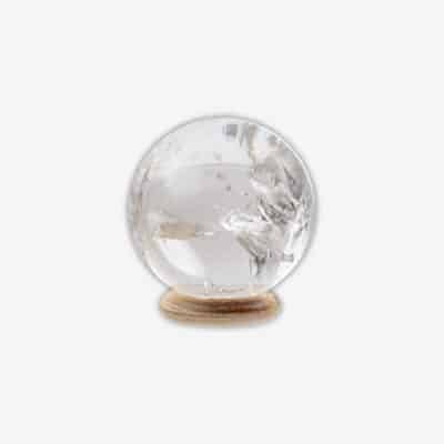 Polished 5cm diameter sphere made from natural  crystal quartz. The sphere comes with a wooden base. Buy online shop.