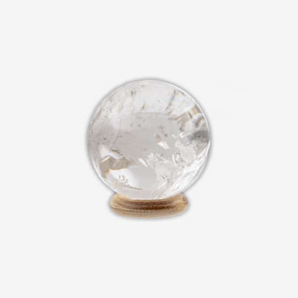 Polished 5cm diameter sphere made from natural  crystal quartz. The sphere comes with a wooden base. Buy online shop.