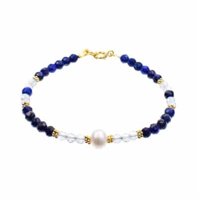 Handmade bracelet made of natural, faceted lapis lazuli and blue topaz gemstones, in a spherical shape. The bracelet has a pearl on its center and gold plated sterling silver decorative elements. Buy online shop.