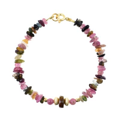 Handmade bracelet with irregular and spherical shaped natural tourmaline gemstones in different colors. The bracelet has a faceted Tourmaline wheel in the center and gold plated sterling silver decorative elements. Buy online shop.
