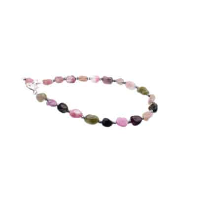 Handmade bracelet made of sterling silver and natural pebble shaped tourmaline gemstones. The bracelet is decorated with faceted hematite gemstone wheels. Buy online shop.