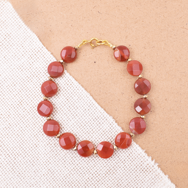 Handmade bracelet made of natural faceted carnelian and pyrite gemstones. The bracelet has a gold plated silver 925 clasp. Buy online shop.