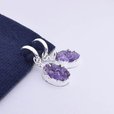 Handmade earrings made of natural, oval shaped amethyst gemstone, in crystal form and silver plated hypoallergenic metal. Buy online shop.