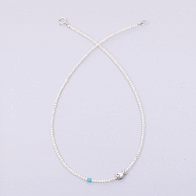 Handmade natural pearl necklace with spherical turquoise stone and a sterling silver fish.